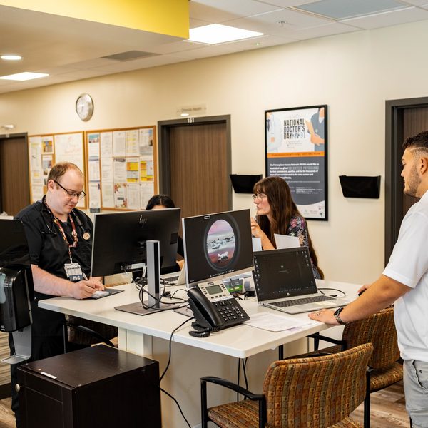 Volunteers working at the front desk of a Shepherd's Hope health center