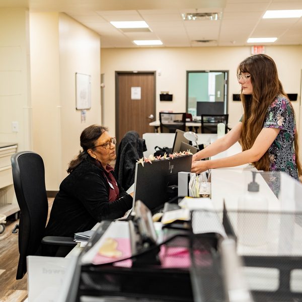A volunteer checking in a patient at a Shepherd's Hope health center