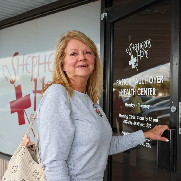 A visitor arriving at the entrance of the Pastor Paul Hoyer Health Center