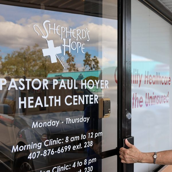 A visitor opening the door of the Pastor Paul Hoyer Health Center